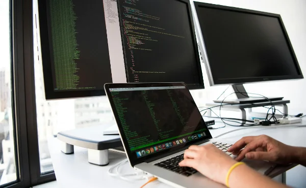 Hands-on laptop-with-coding-screen